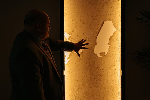 The breached front door from Congregation Beth Israel synagogue of Colleyville, Texas, sits on display in the offices of the Secure Community Network. Credit: Jamie Kelter Davis for The New York Times